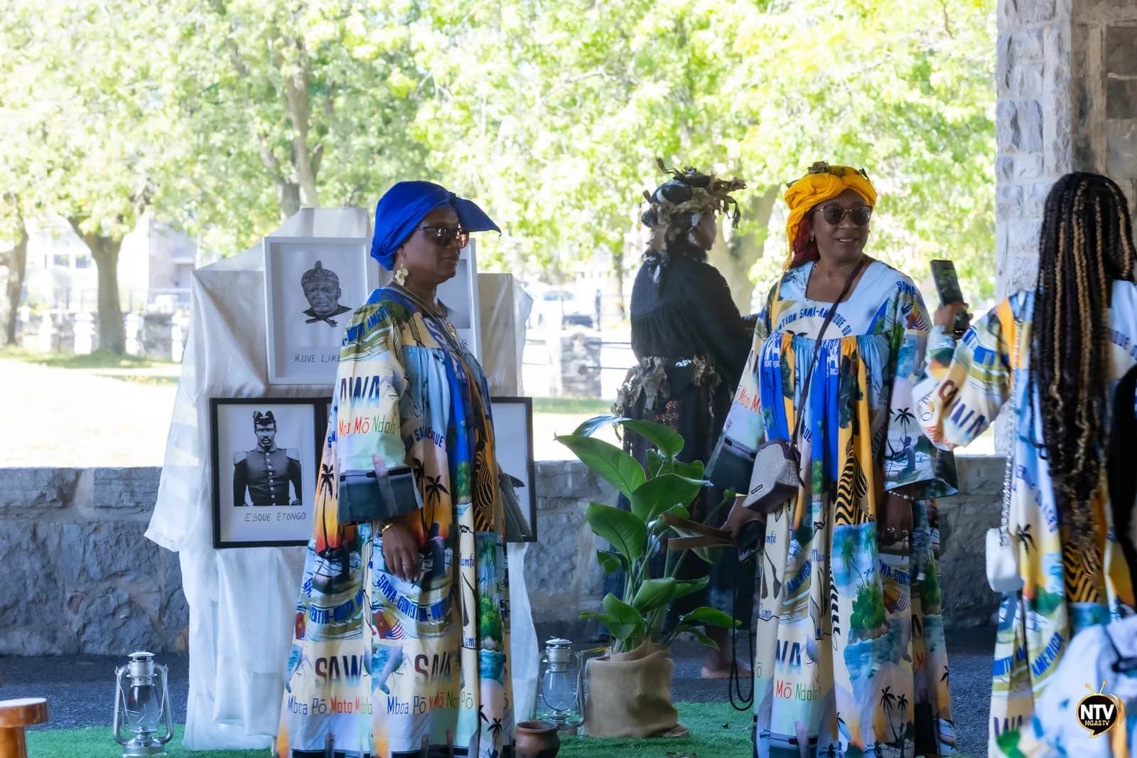 Tribute ceremony to the Sawa martyrs with participants in traditional attire and historical portraits.